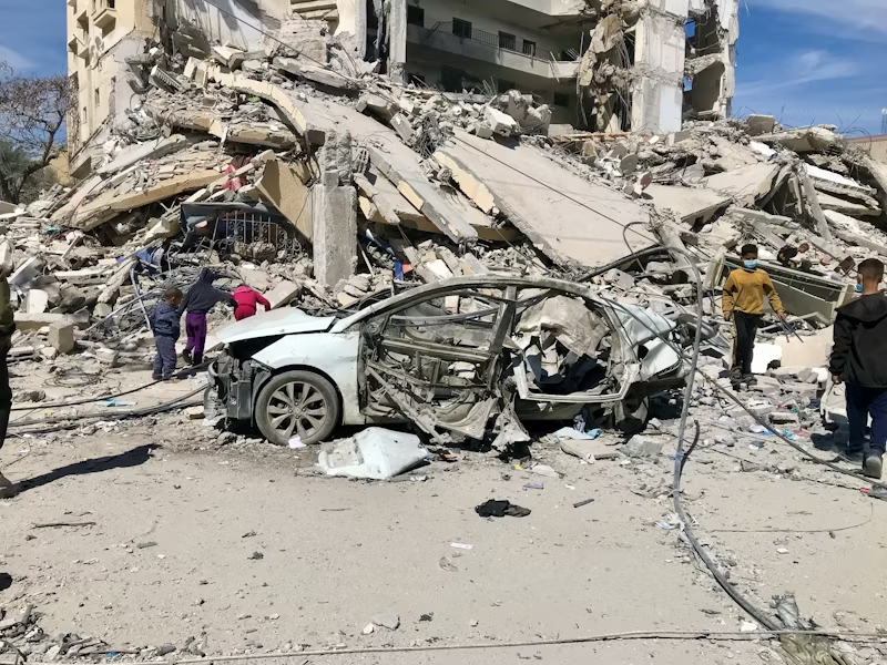 demolished city with people around