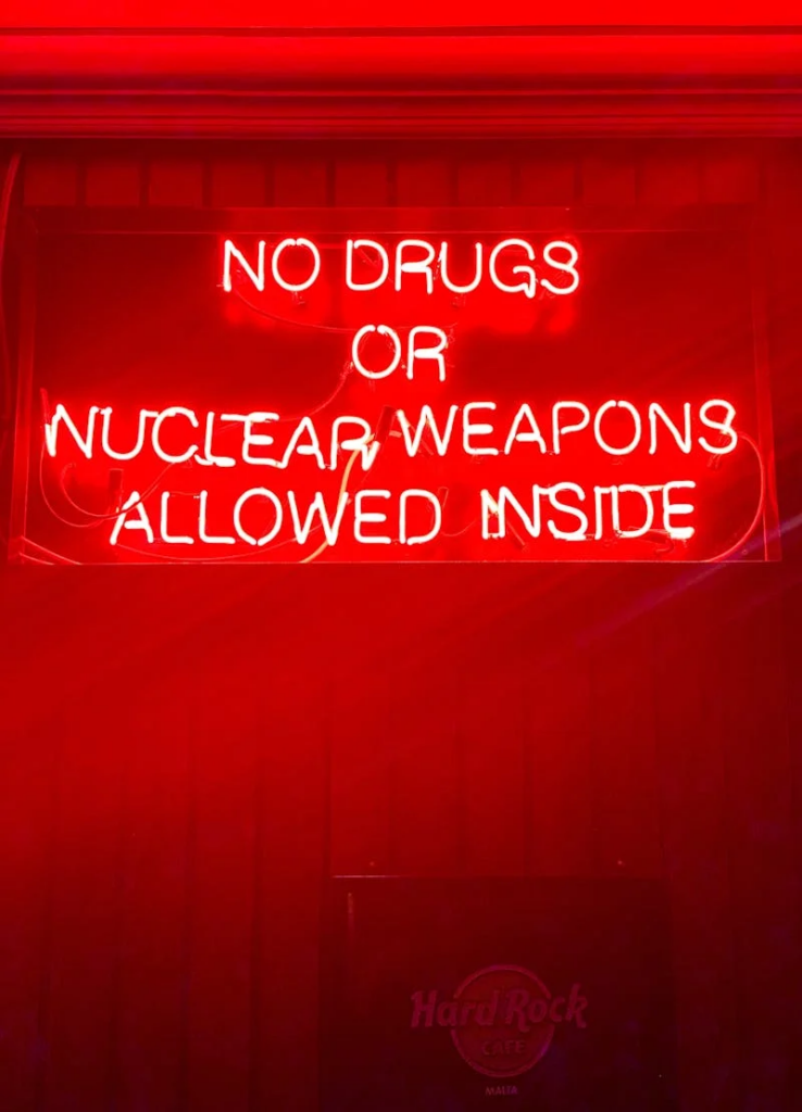 neon sign "no drugs or nuclear weapons allowed inside"
