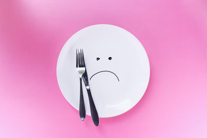 frowning empty plate with fork and knife