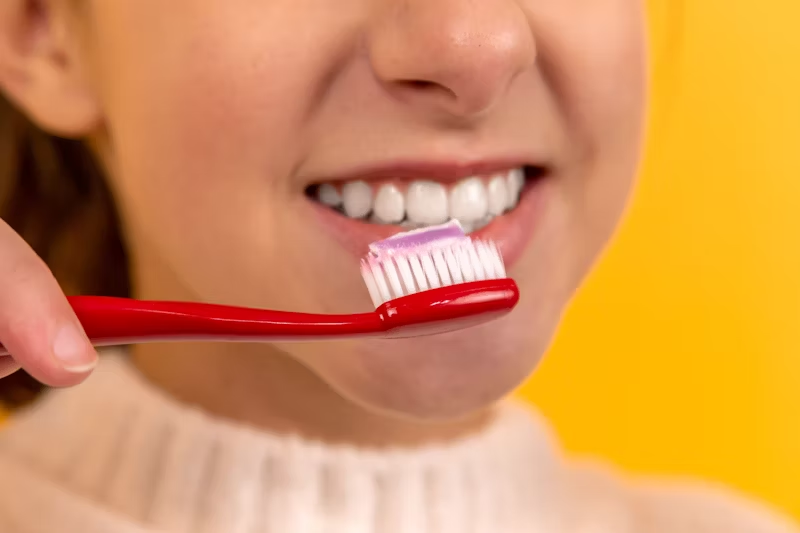 person brushing their teeth