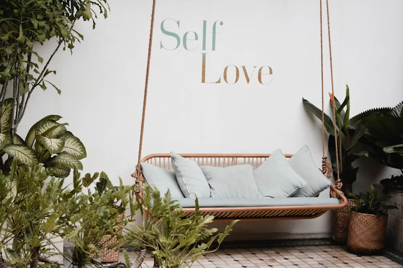swinging bench under a sign that reads "Self Love"