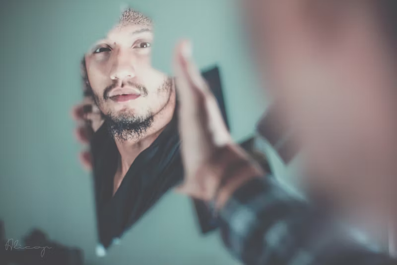 man looking at his reflection 