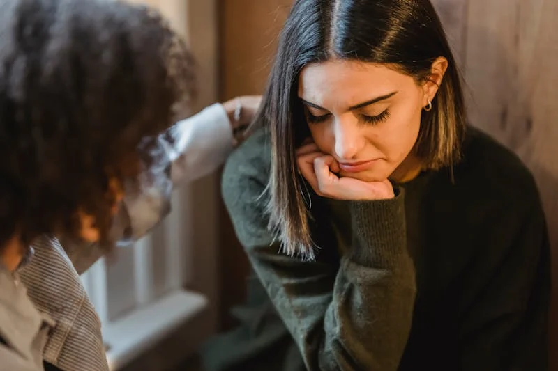 downtrodden woman being empathized with