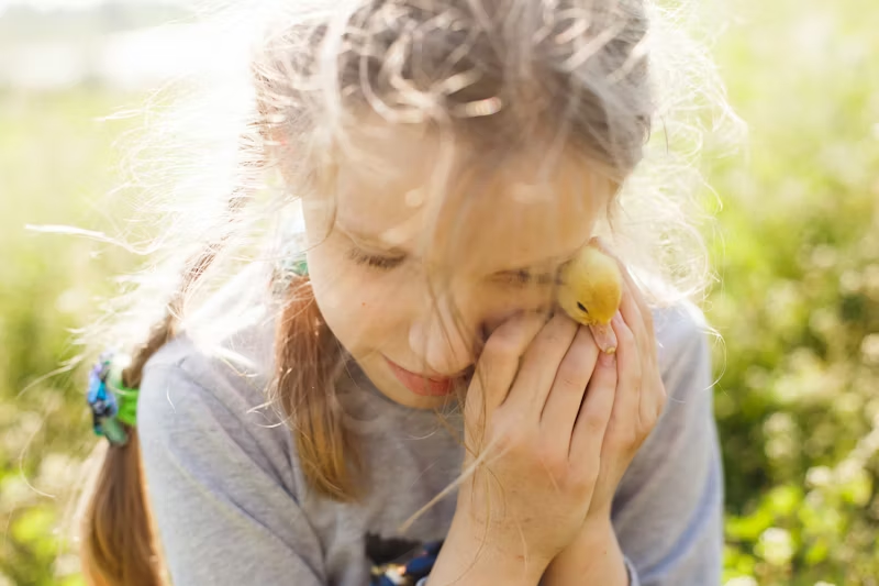 young white girl with a duckling