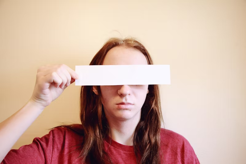a woman with a strip of paper over her eyes