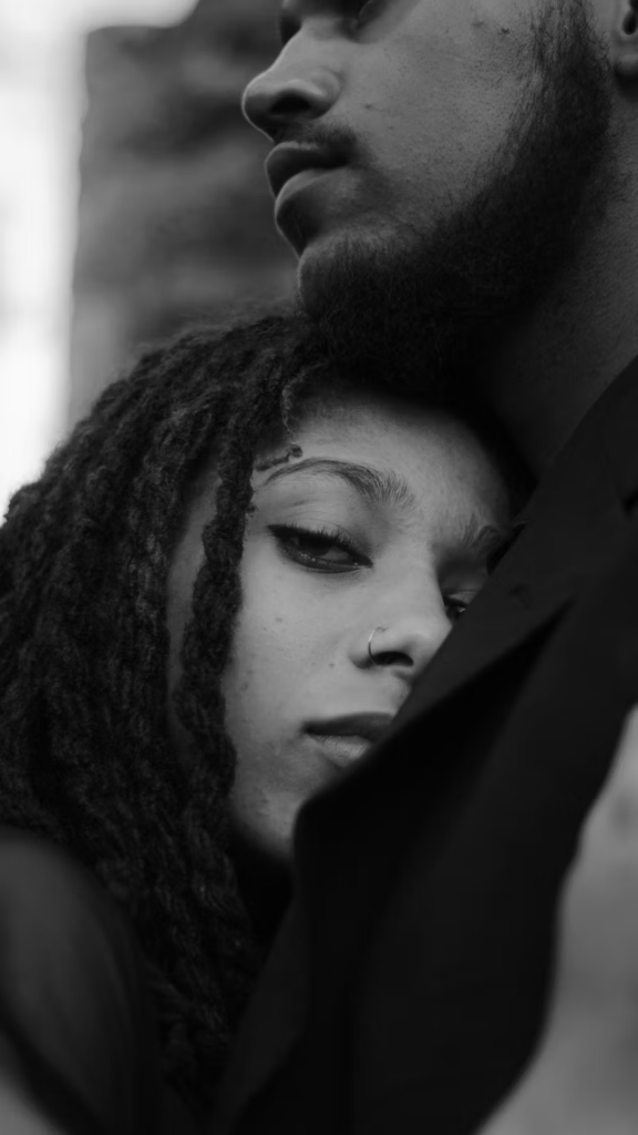 a woman laying her head in a mans chest