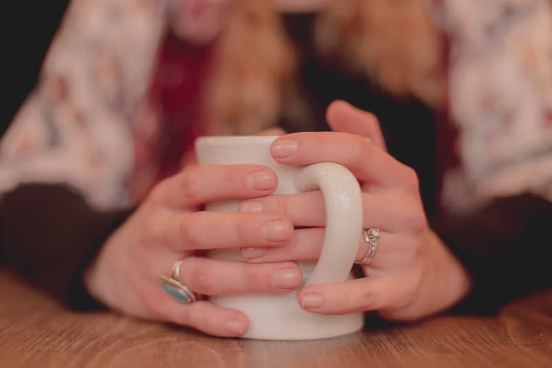 hands wrapped around a mug