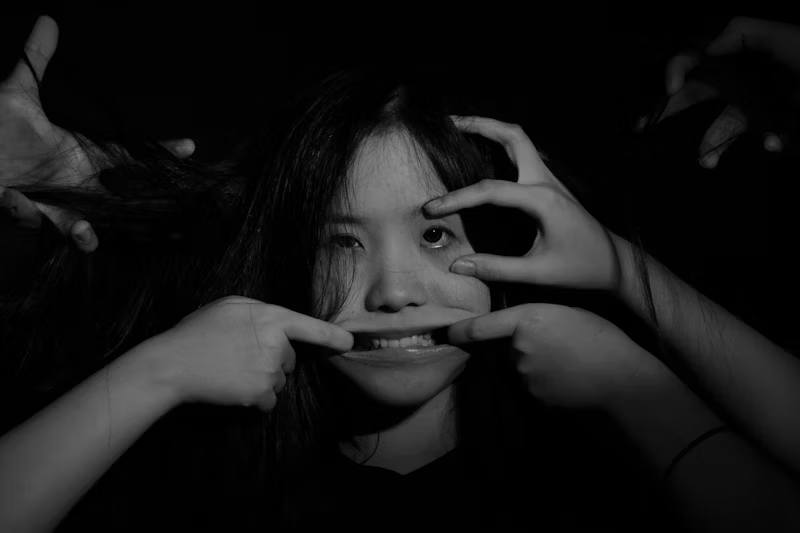 a woman's face is puled and manipulated