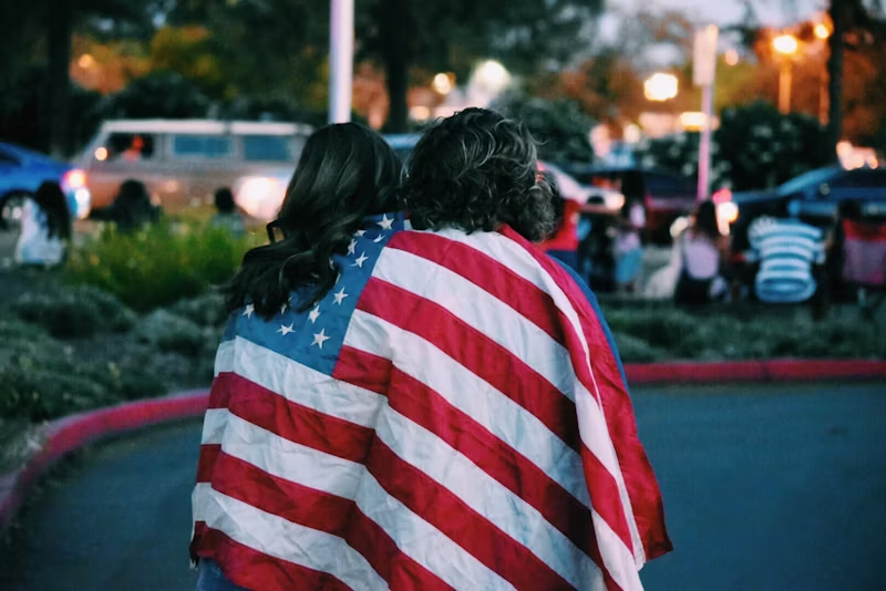 two people under an American flag