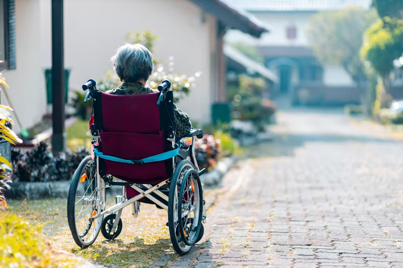 a woman in a wheelchair looking away
