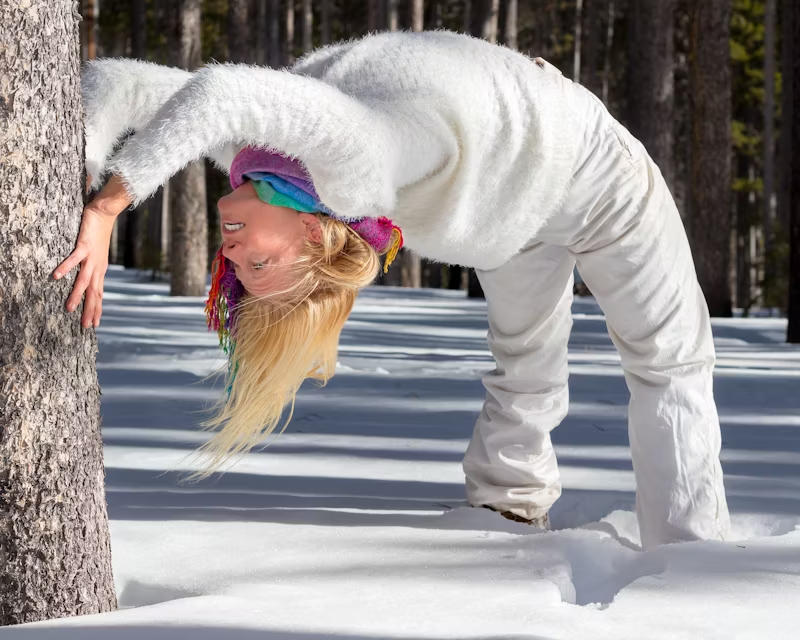 woman winter gear arching snow