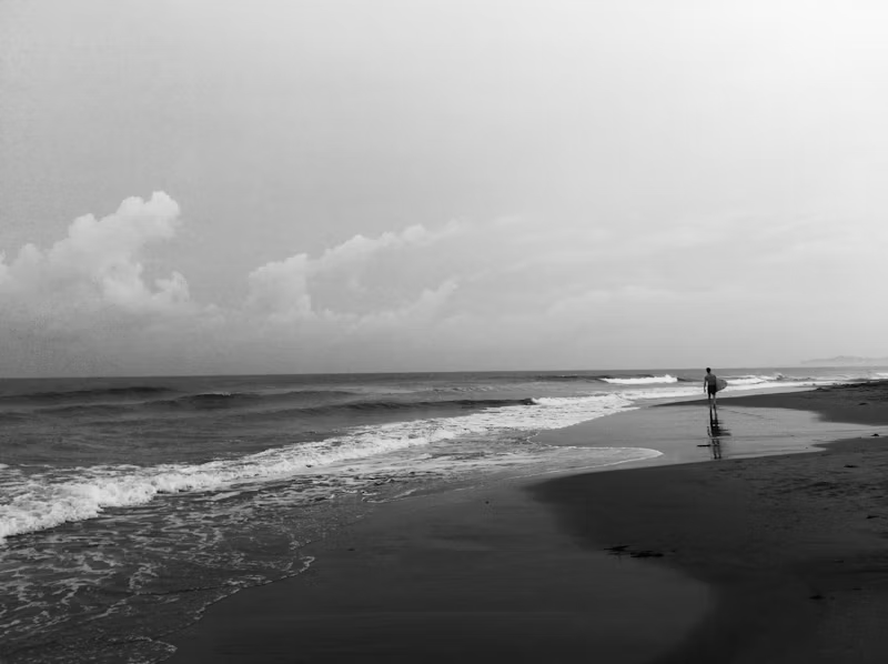 perso surfboard beach black white