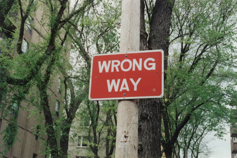 wrong way'sign telephone pole