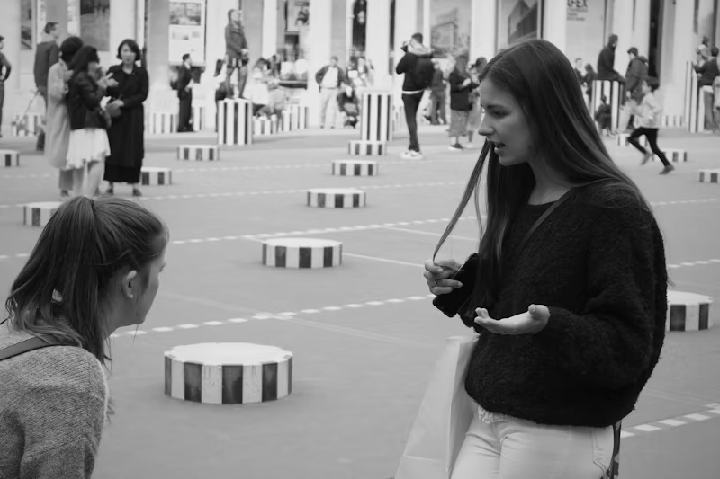 two girls talking at an event