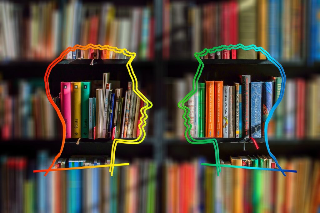 two different coloured silhouette heads facing each other