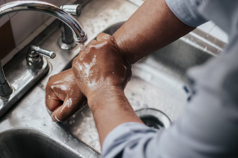 a man washing his hands in the sink