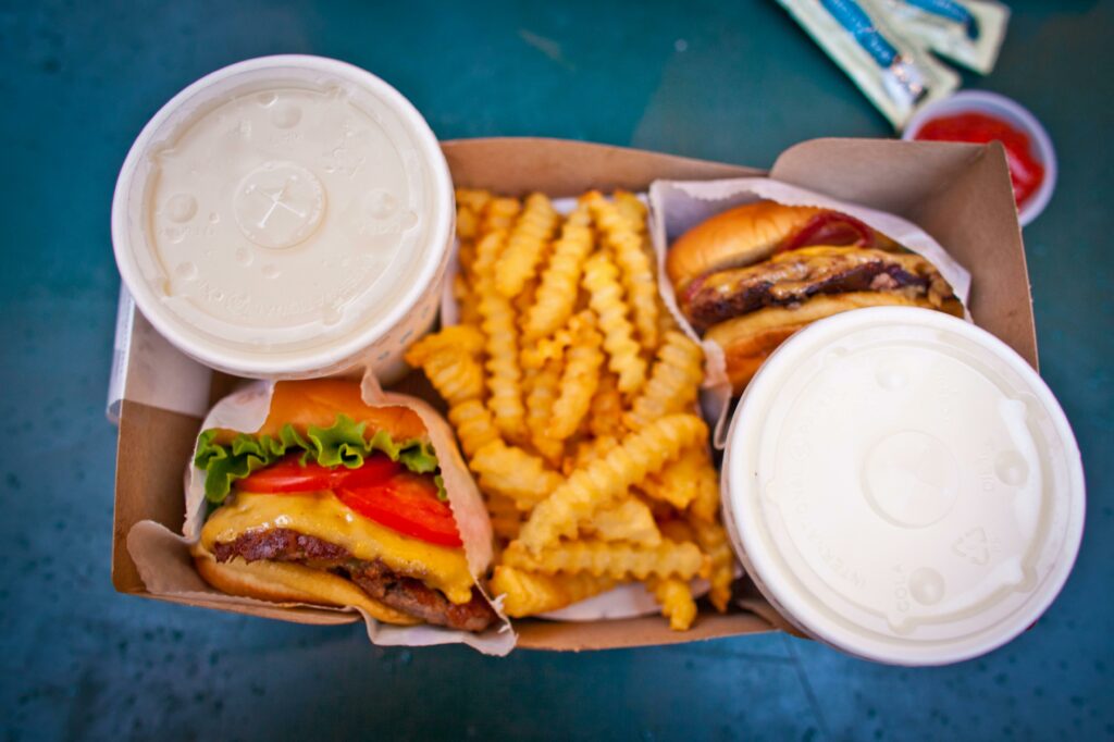 two burgers with soda and fries 