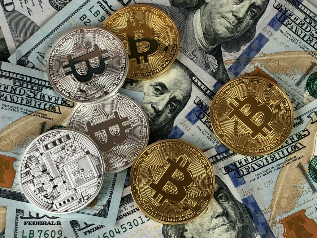 bitcoins and dollar bills 