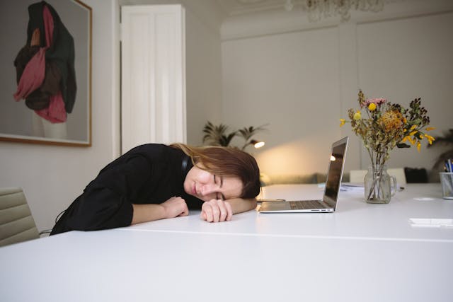 woman sleeping at desk