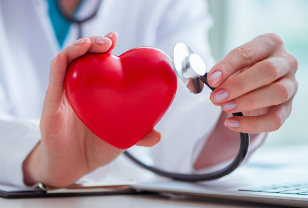 Doctor checking up heart in medical concept
