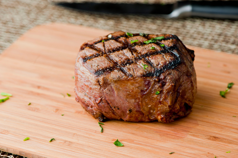 Filet mignon. Grade A grass fed angus beef steak. Tenderloin, filet mignon, New York strip, bone in rib-eye grilled medium rare on outdoor grill. Classic American steakhouse entree favorite.