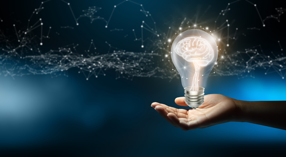 Businessman holding Light bulbs with Brain inside and Low poly wireframe outside. Creative and innovation inspiration. Business Bright idea concept.