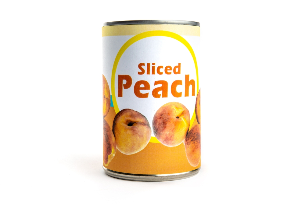 A fake generic labelled food can of sliced peach isolated on white
