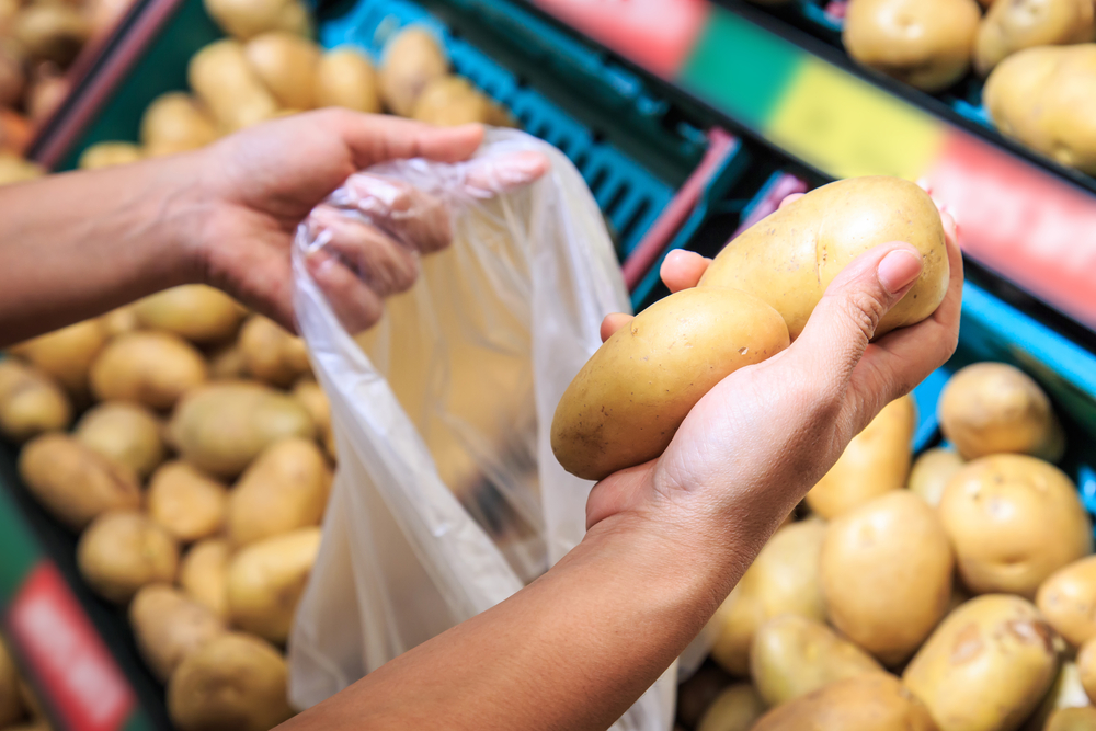 Woman holding Potato and shopping in department store
