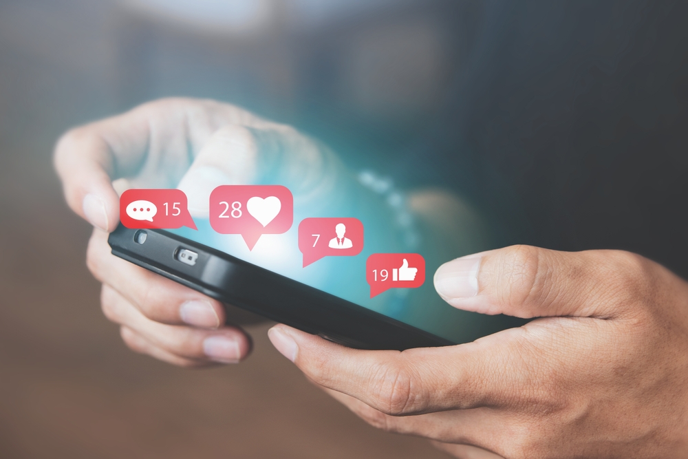 Men use smartphones to interact with social media. following news, communicating with others through emojis and online messages, notifications, opinions, or internet digital marketing creation.

