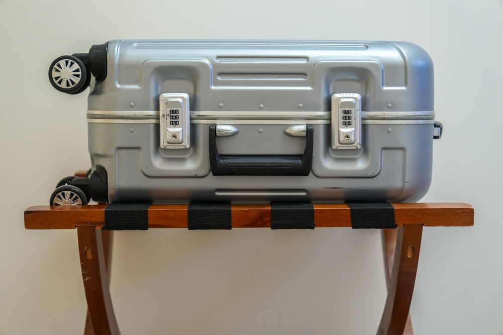 Suitcase on wooden luggage rack