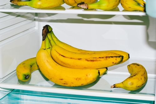 group of ripe bananas in the fridge,household appliance for home food storage,fruit close-up