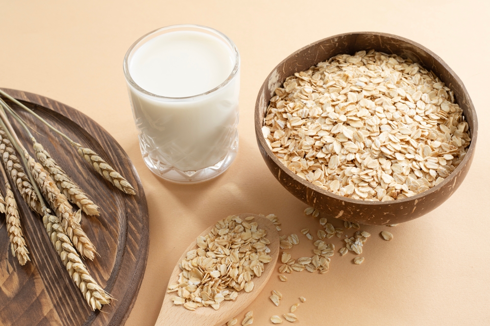 Oats and oat milk against on beige background. Healthy lifestyle, healthy nutrition, vegan food concept