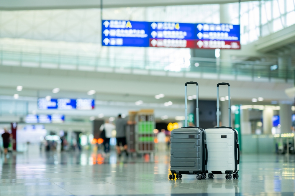 Travel, Two suitcases in an empty airport hall, traveler cases in the departure airport terminal waiting for the area, vacation concept, blank space for text message or design