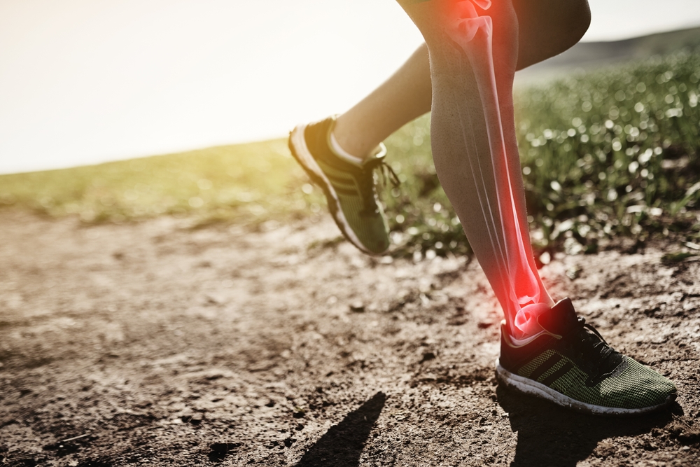 Man, legs and fibromyalgia pain for running, outdoor and bone or joint injury in countryside or arthritis. Male person, athlete and osteoarthritis or stress tension on body, exercise and fracture