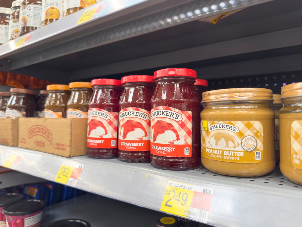 Los Angeles, California, United States - 04-14-2024: A view of several jars of Smucker's strawberry topping, on display at a local grocery store.
