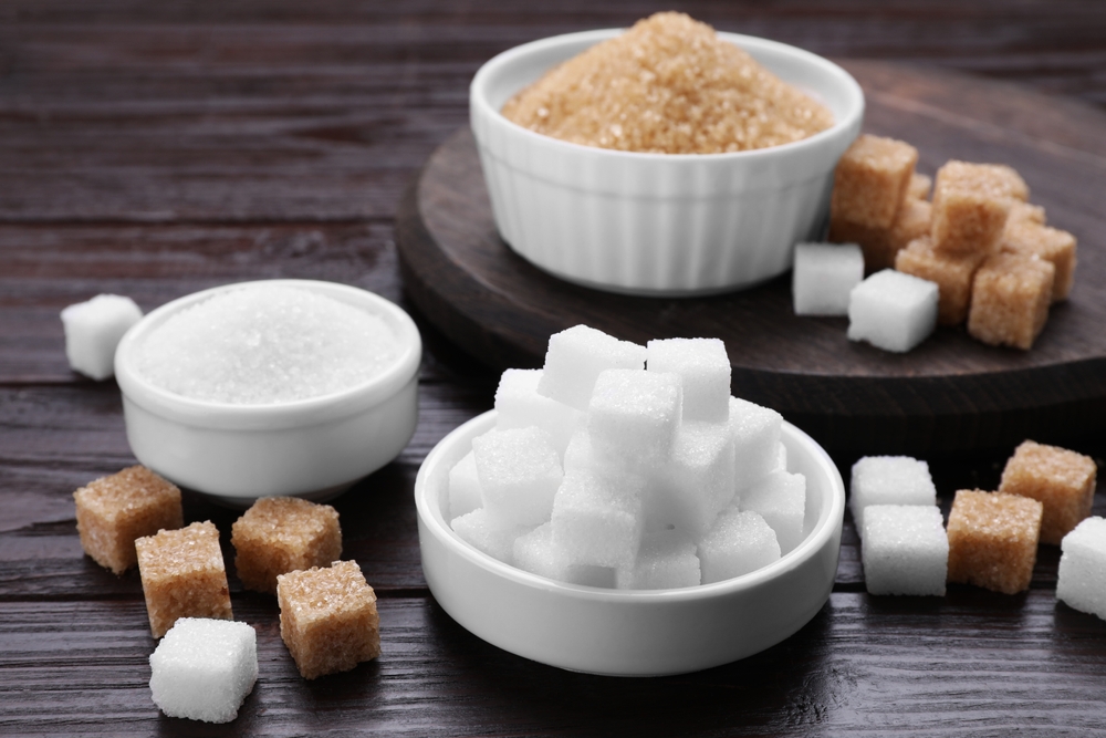 Different types of sugar on wooden table

