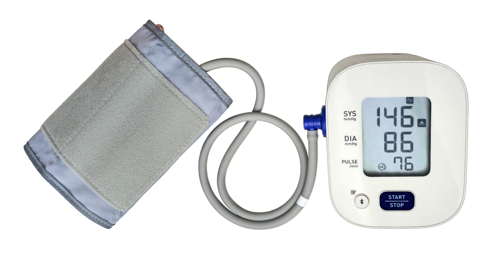 Digital Blood Pressure Monitor to measure blood pressure and heart rate isolated on white background with clipping path. Automatic electronic medical device. High blood pressure measurement on screen.