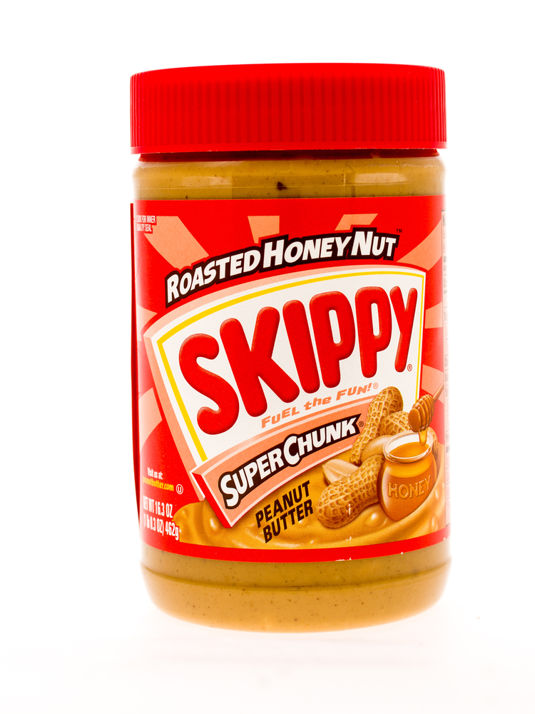 Winneconne, WI - 3 May 2015: Jar of Skippy peanut butter roasted honey nut flavor in super chunk style.
