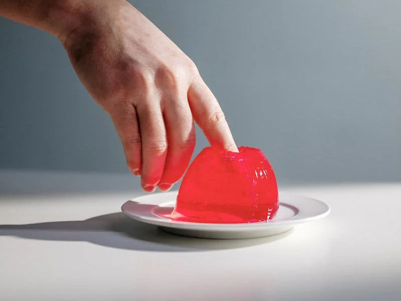 a finger poking into some jello