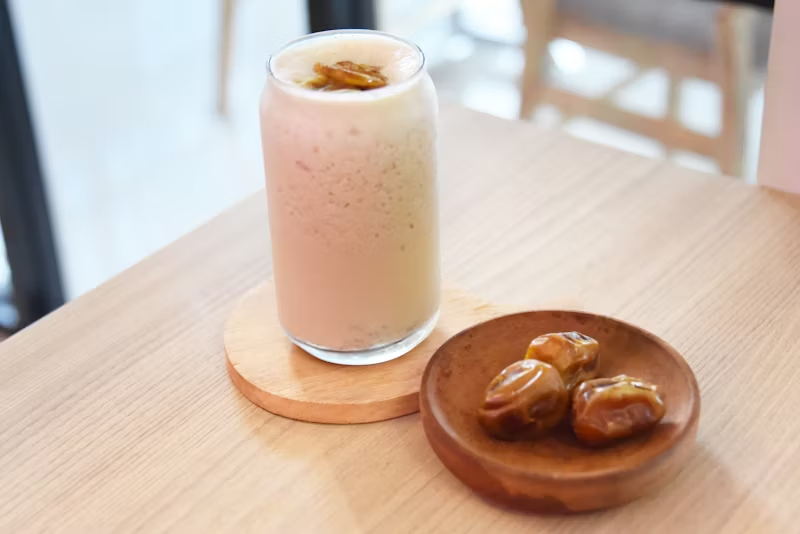a smoothie with dates on the side