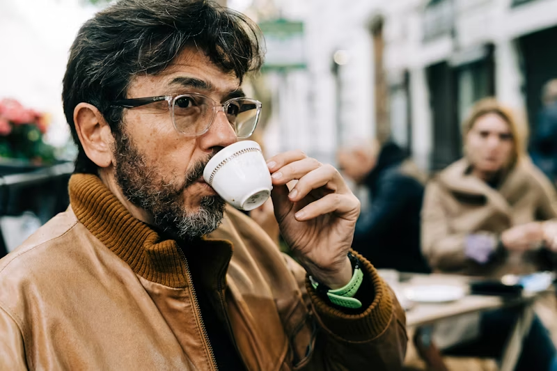 a man sipping an espresso
