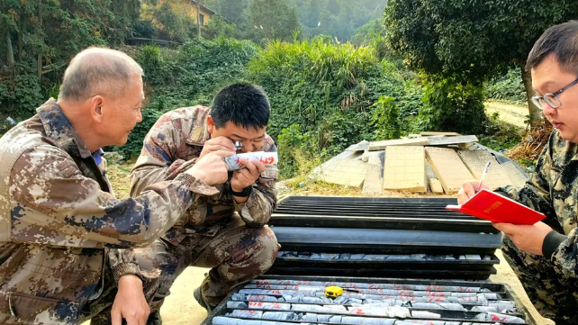 Technicians of Hunan Province Geological Disaster Survey and Monitoring Institute check rock samples at the Wangu gold field in Pingjiang County, central China's Hunan Province, 5 November 2024. 