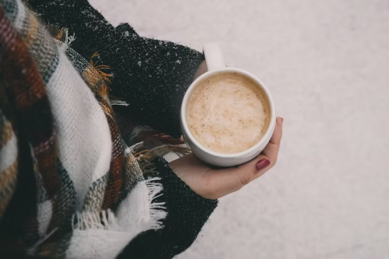 hands outside holding a warm drink