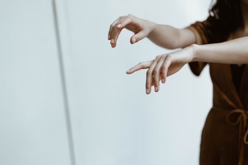 a woman looking at her fingernails
