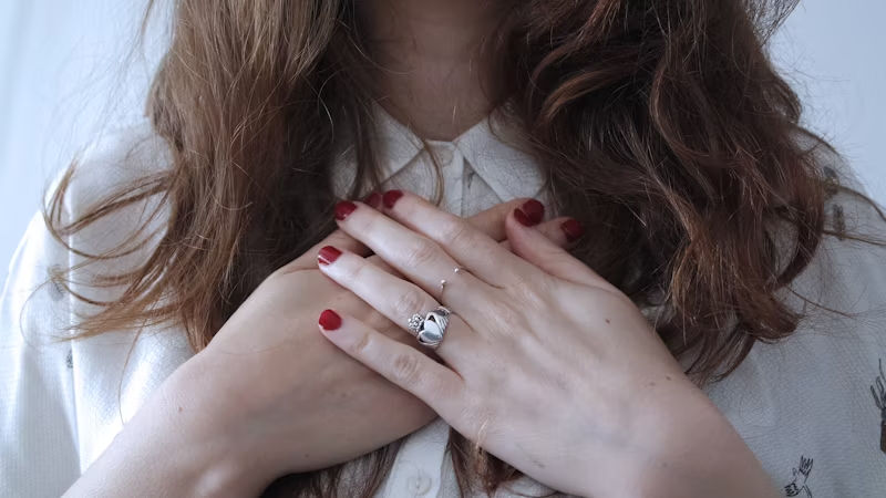 a woman holding on to her chest