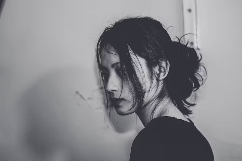 black and white photo of a woman looking depressed