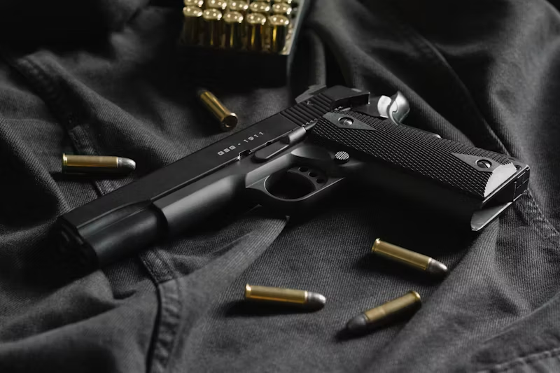 a handgun and bullets on cloth