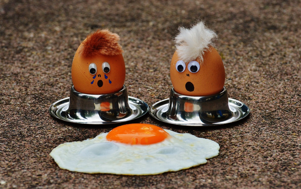 two eggs lamenting their cooked friend