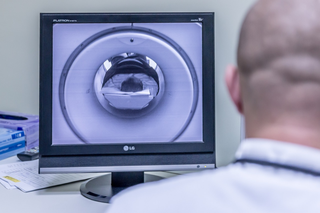 man watching MRI camera