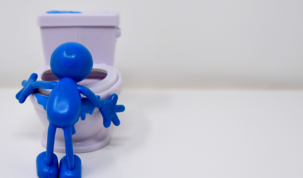 stick figure throwing up in a tiny toilet